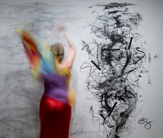 Self.Portrait_DSC03982.Crop2.Lo.Res A woman in movement in front of a painting